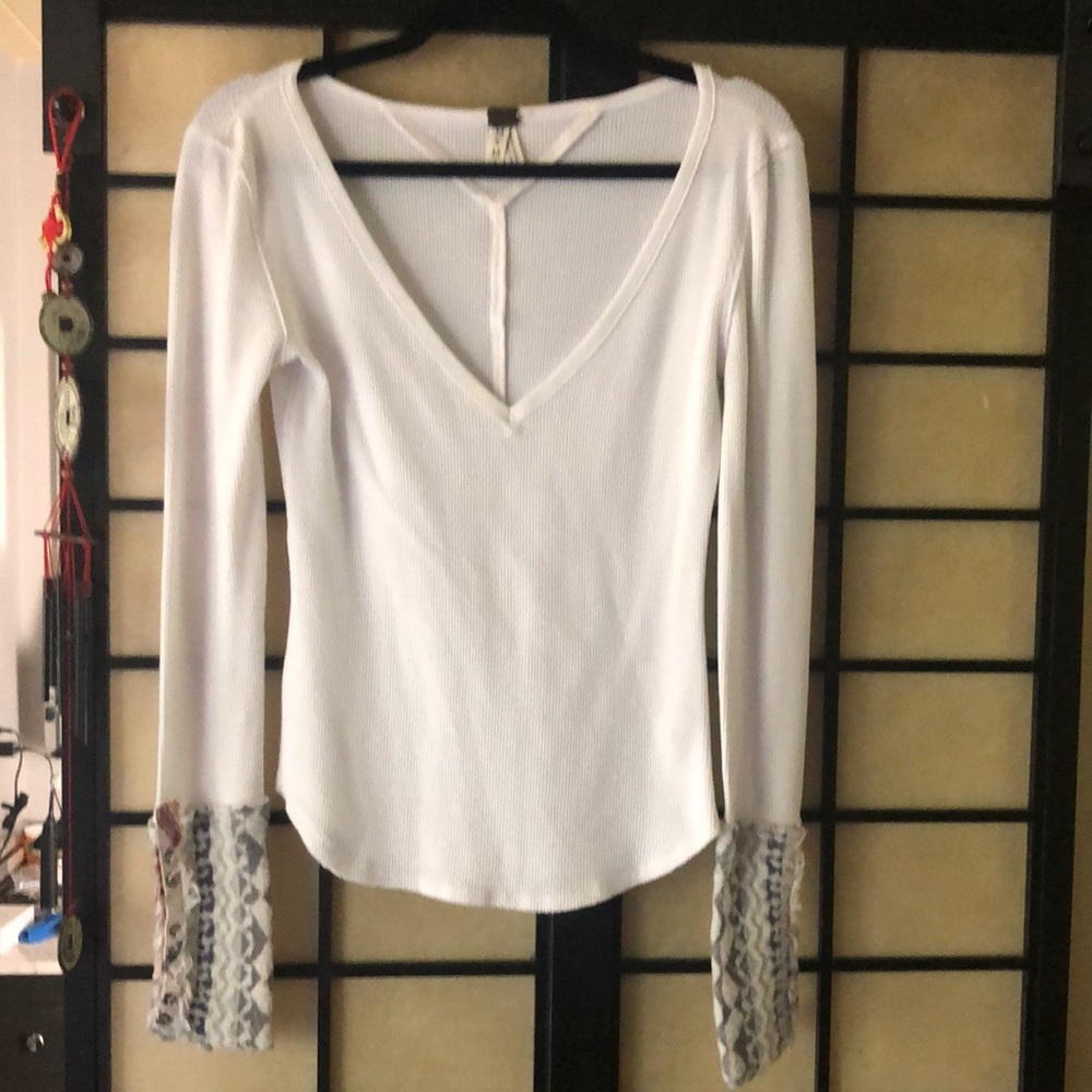 This Free People top is cream colored with fun cuffs!